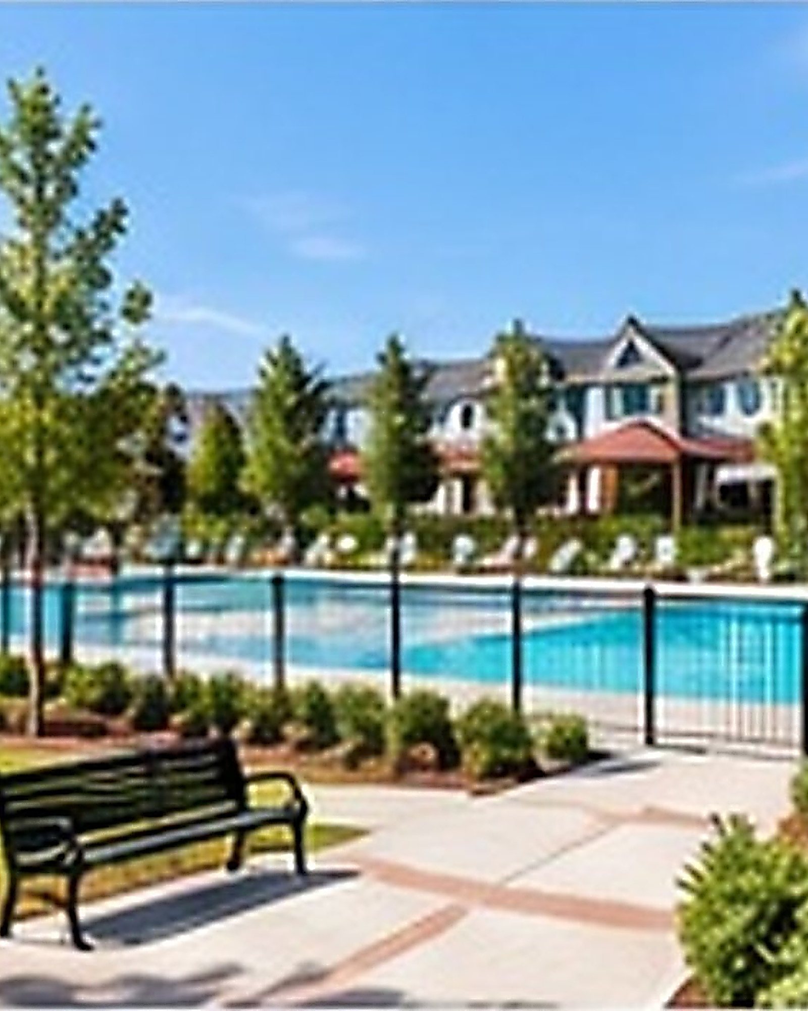 Community park with walking paths, benches and a pool