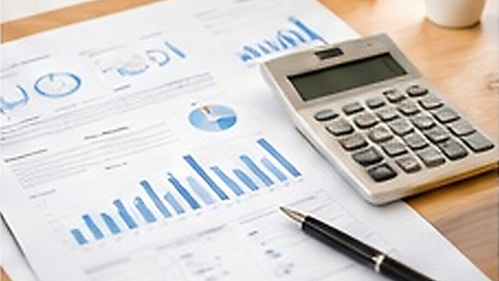 Financial reports and a calculator on a desk
