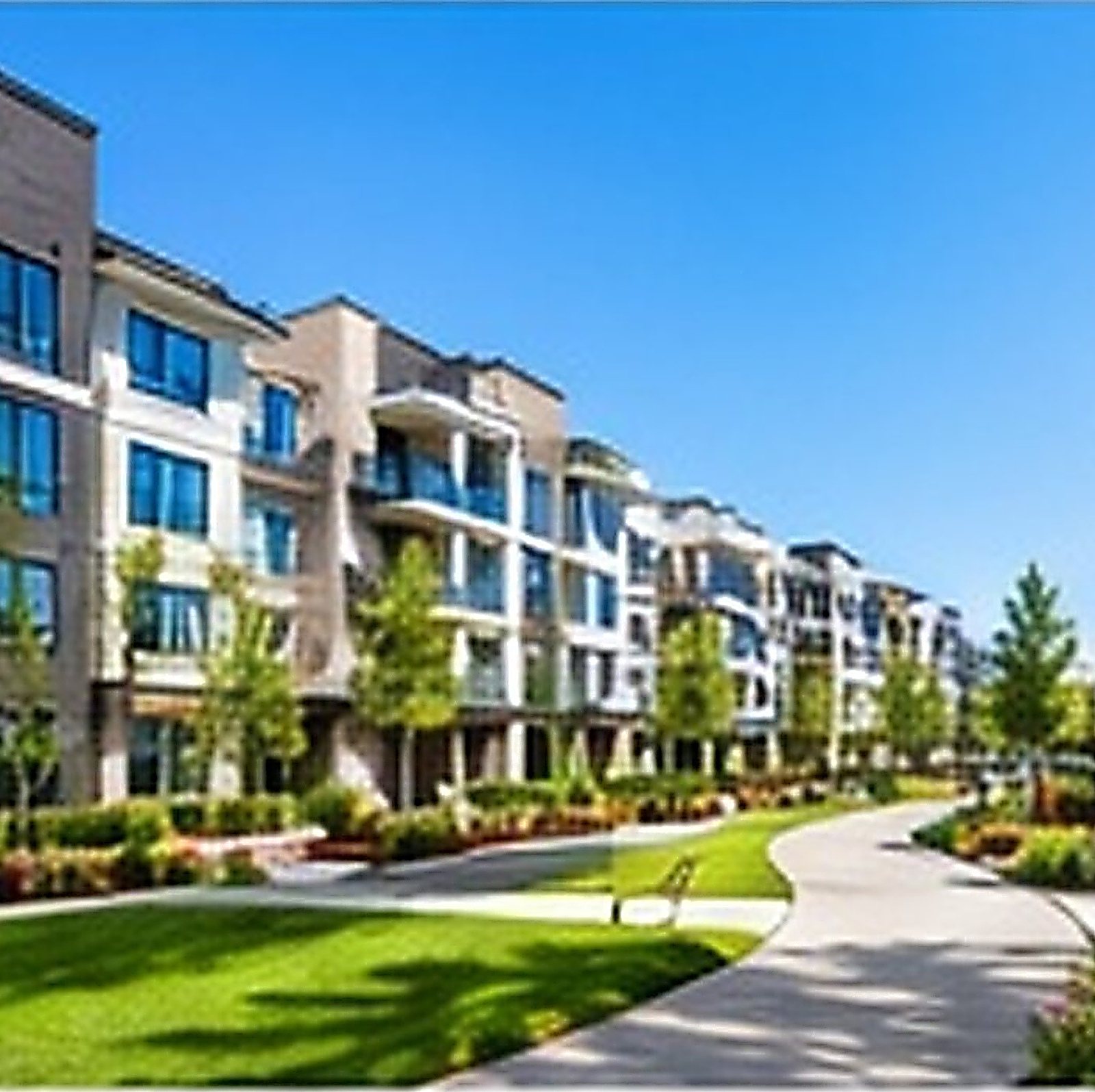 Modern residential community with landscaped walkways and green lawns
